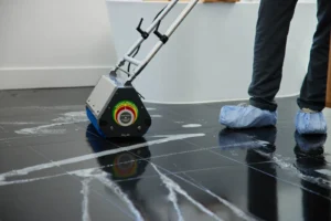 High-pressure hot water cleaning of dirty grout lines on a commercial tile floor